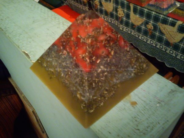pyramid orgonite in beeswax, with huge crystal and shungite, flowers