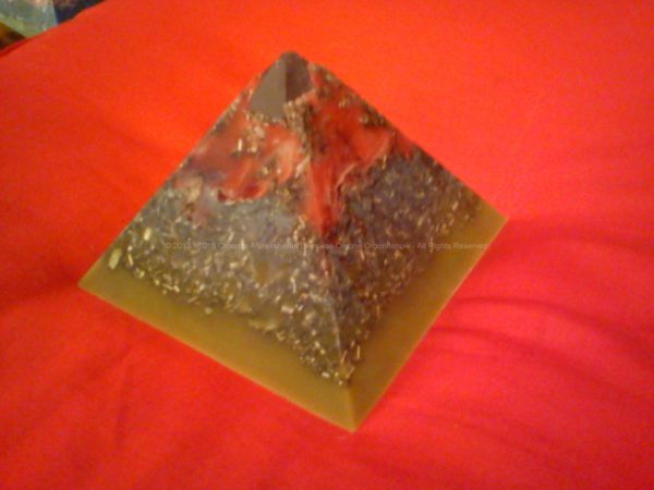 pyramid orgonite in beeswax, with huge crystal and shungite, flowers
