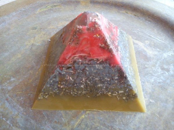 Pyramid orgonite with a big hyalin quartz on top and a big shungit on the heart.