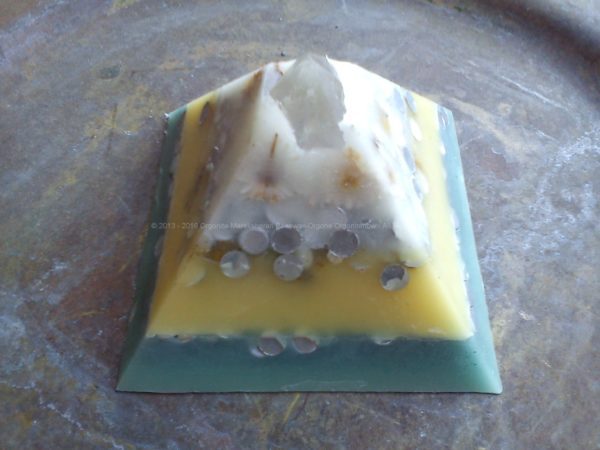 Pyramid orgonite with a big hyalin quartz on top and a big shungit on the heart.