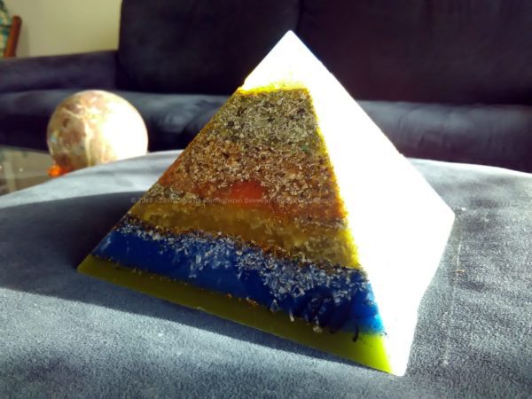 Ionio, 12 cm pyramid orgonite done with an opalite pyramid, blue apatite beeswax and metals, plus one piece of shungite under the pyramid.